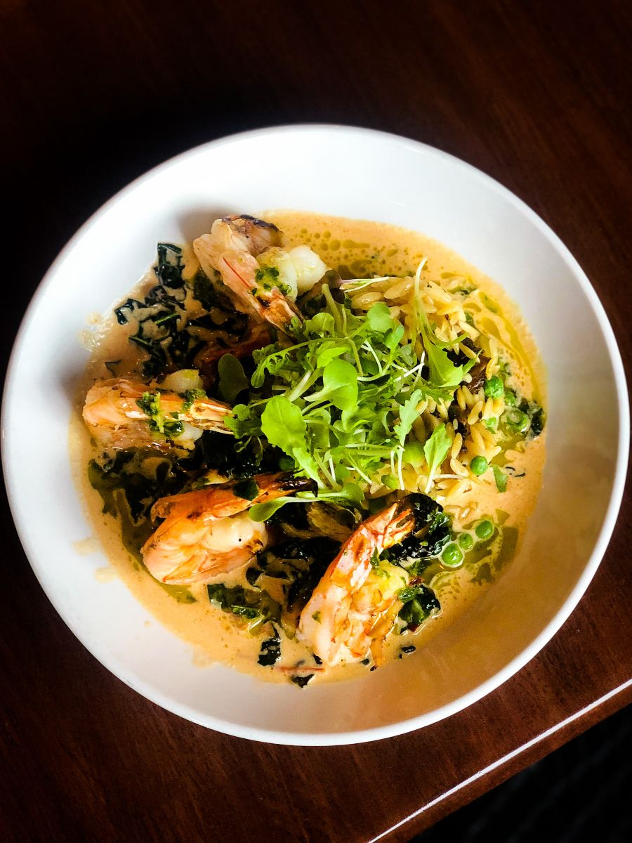 shrimp-fennel Citrus Marinated, Grilled Shrimp, Local Oyster Mushroom and Sweet Pea Orzo, Tomato Fennel Cream Sauce, Wilted Kale, Basil-Parsley Chimichurri
